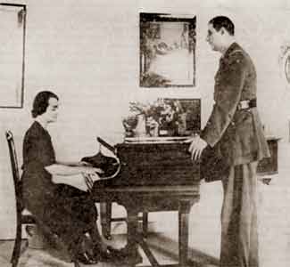 The General, in London, looking at Madame de Gaulle playing the piano...